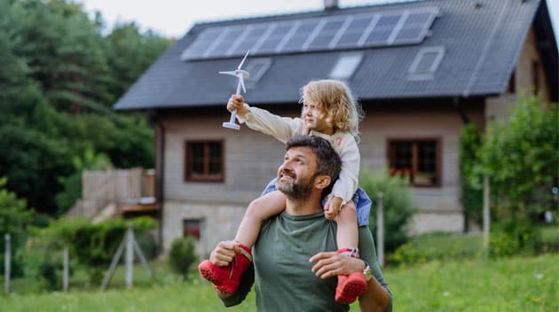 Father and child playing infront of home