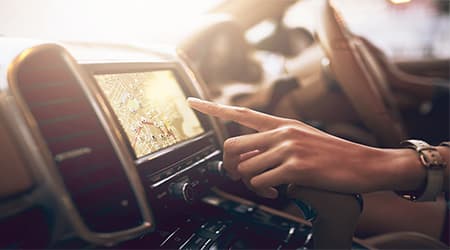Driver using their car navigation panel