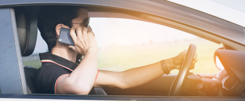 Man using mobile phone while driving