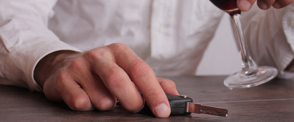 Man with keys and wine glass