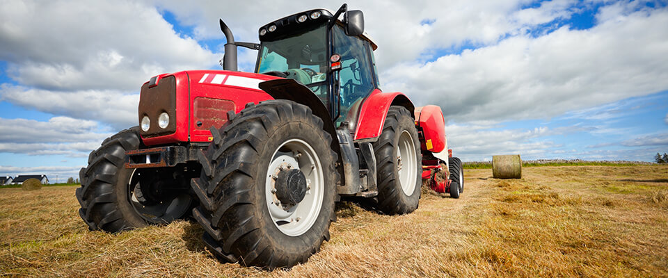 Red tractor in wheat field