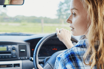 Woman looking out car window