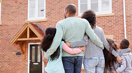 Family standing outside of their home
